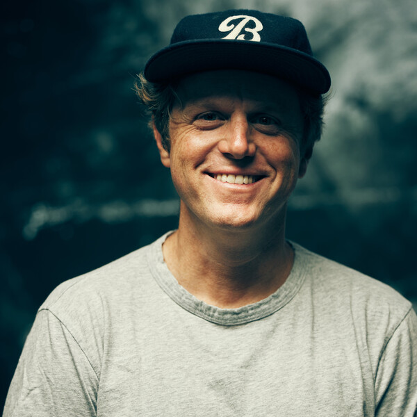 Filmmaker Ryan Ross smiling in a portrait photo, director of the film about Omari Cato.